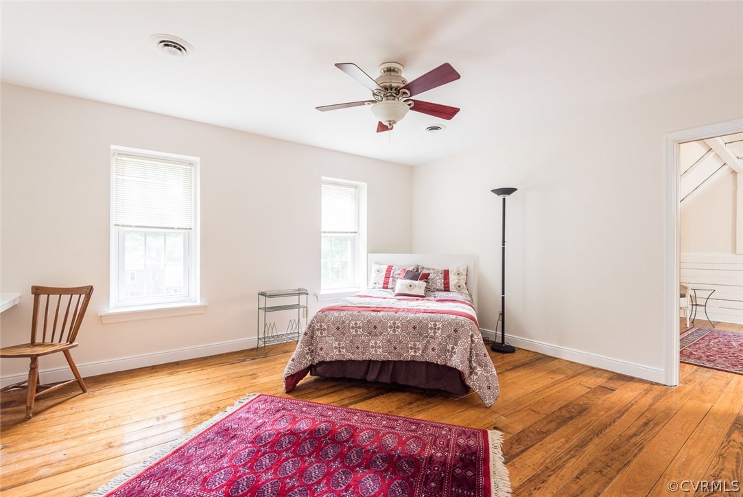13224 Queensgate Road Midlothian, VA 23114 - Photo 23 of 32 a bedroom with a bed and wooden floor