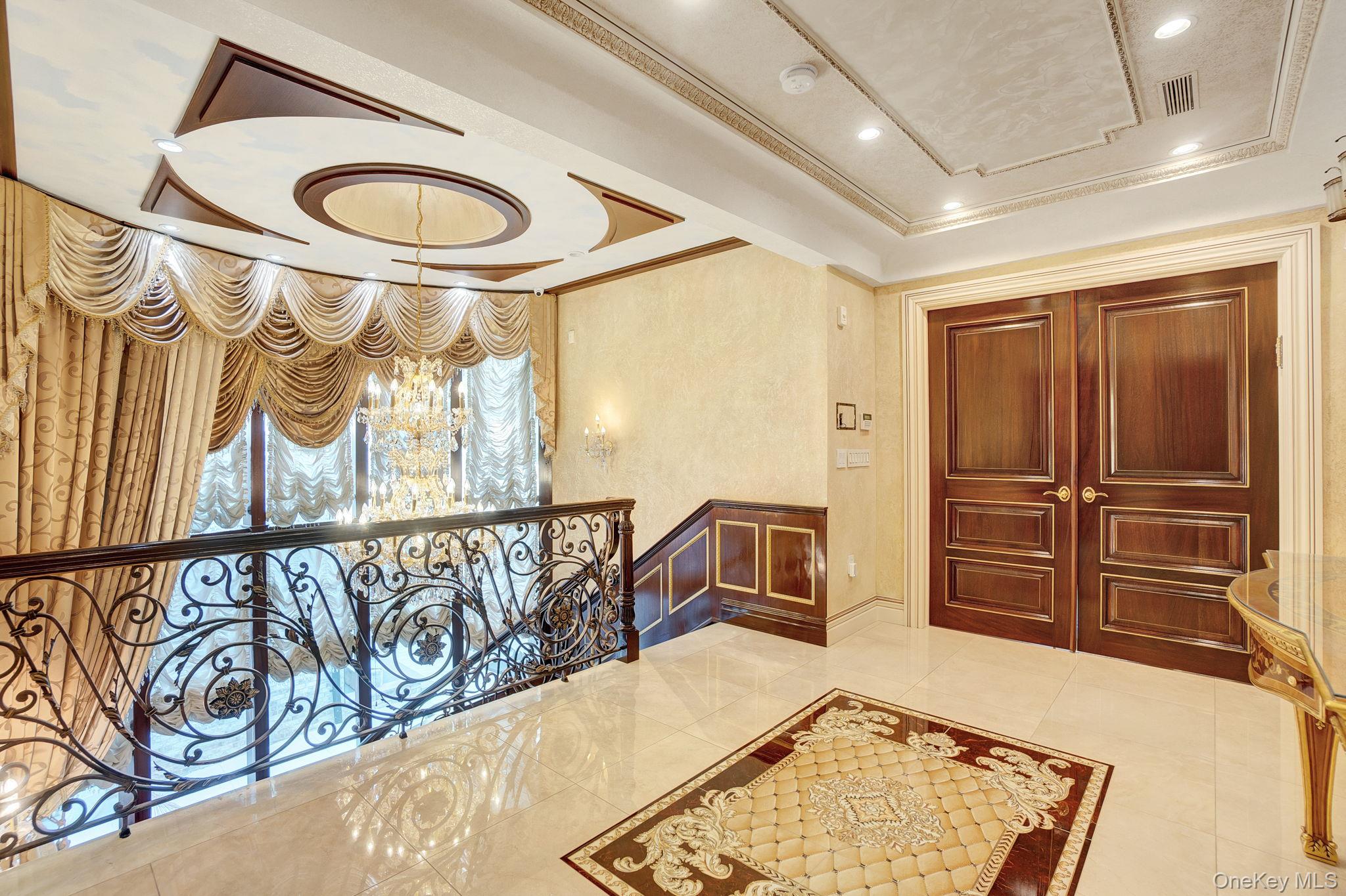 181-30 Tudor Road Queens, NY 11432 - Photo 21 of 46 Hall featuring ornamental molding, a chandelier, a raised ceiling, recessed lighting, and tile patterned flooring