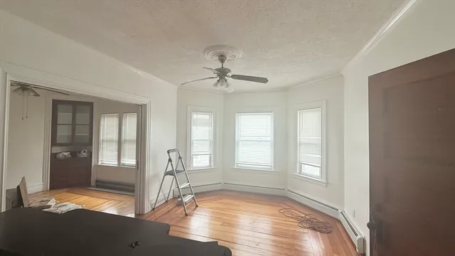 a view of livingroom with hardwood floor and a ceiling fan