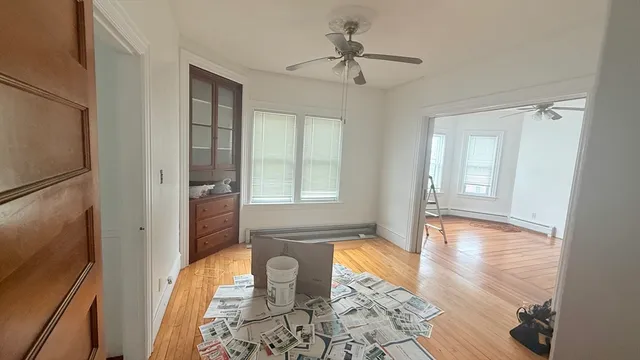 a view of an entryway with wooden floor and a livingroom