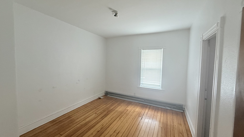 37 Berkley Street, Unit 2 Fall River, MA 02724 - Photo 7 of 11 a view of an empty room with wooden floor and a window