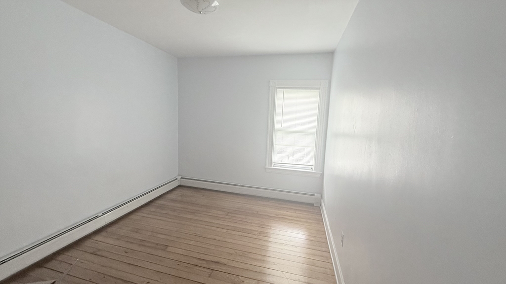 37 Berkley Street, Unit 2 Fall River, MA 02724 - Photo 8 of 11 an empty room with wooden floor and windows