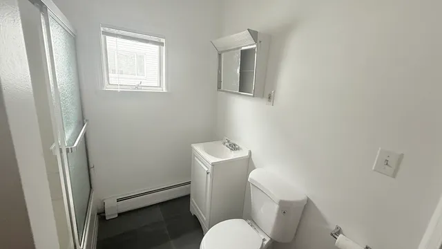 a white toilet sitting next to a bathroom sink