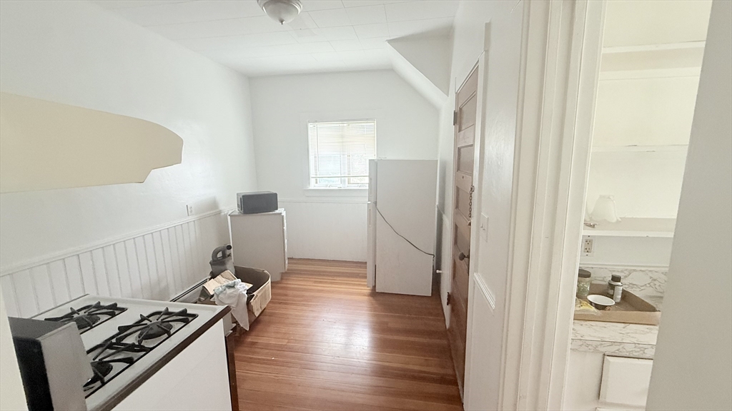 37 Berkley Street, Unit 2 Fall River, MA 02724 - Photo 10 of 11 a kitchen with a refrigerator and a stove top oven