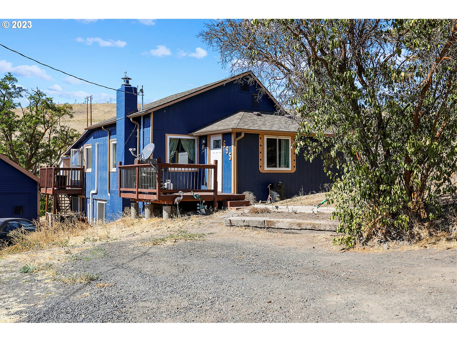 a view of a house with a yard covered in snow