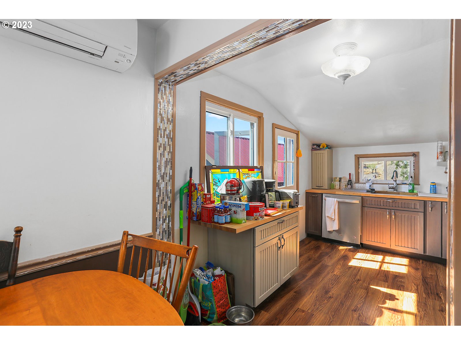 695 Main Street Dufur, OR 97021 - Photo 11 of 42 a kitchen with a stove a refrigerator and a dining table