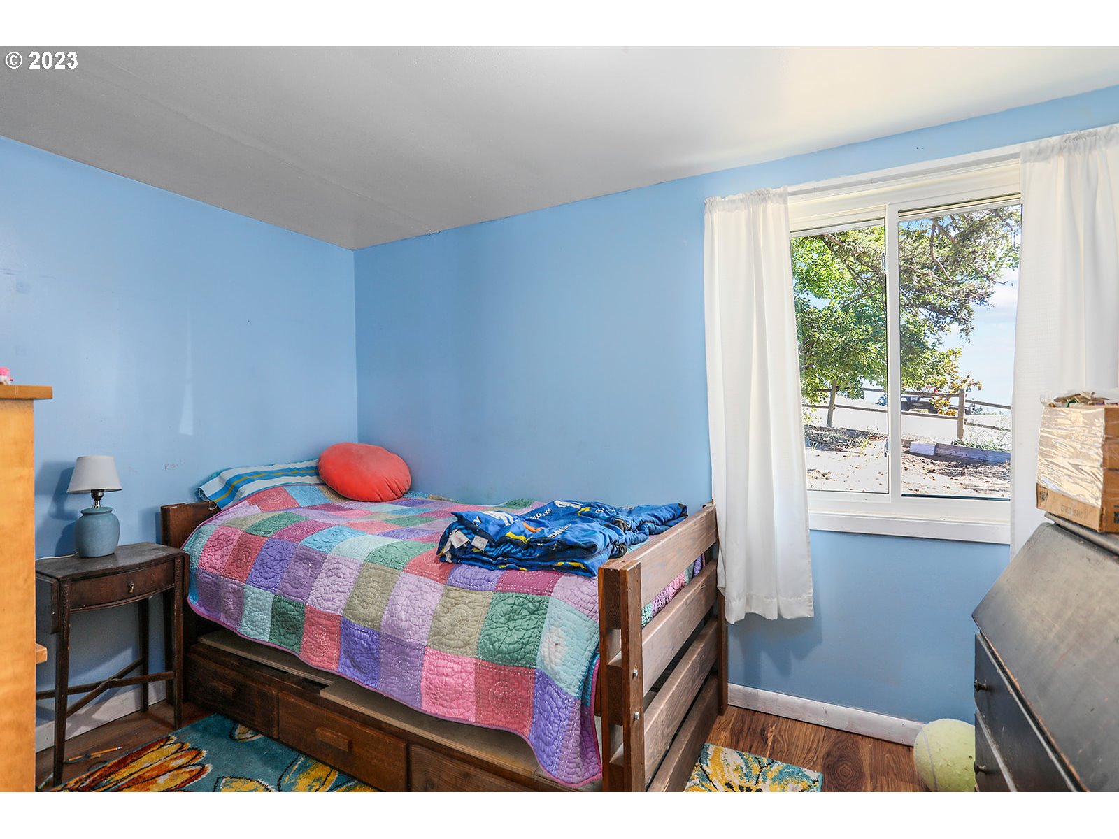 695 Main Street Dufur, OR 97021 - Photo 13 of 42 a bedroom with a bed and large windows