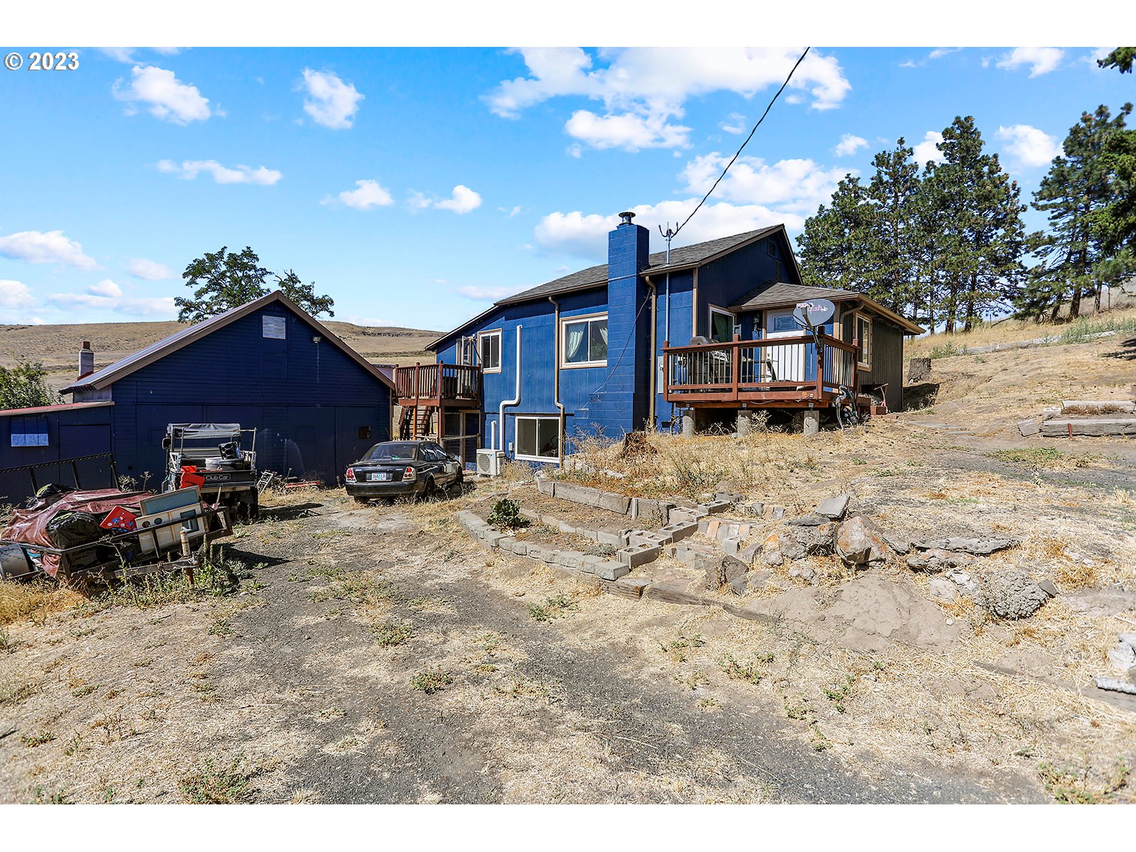 695 Main Street Dufur, OR 97021 - Photo 2 of 42 a view of a house with a yard covered in snow