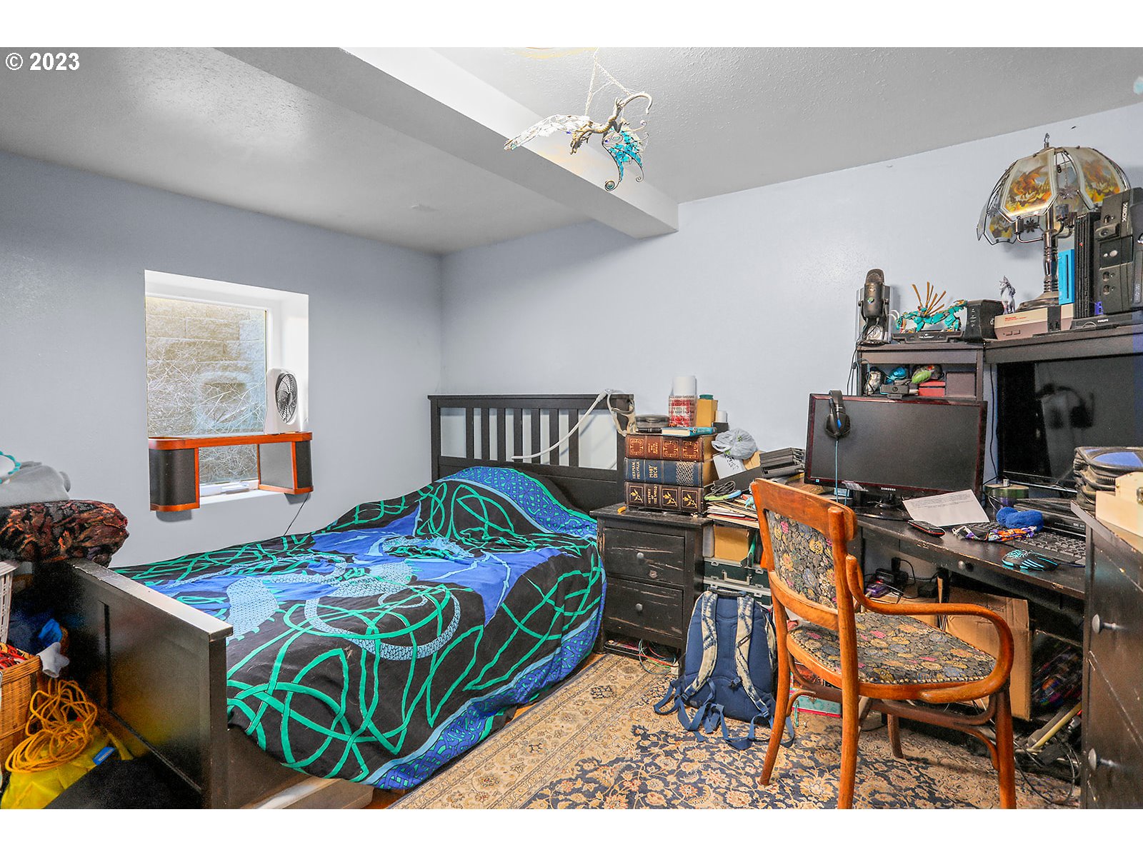 695 Main Street Dufur, OR 97021 - Photo 23 of 42 a bedroom with a bed table and a window