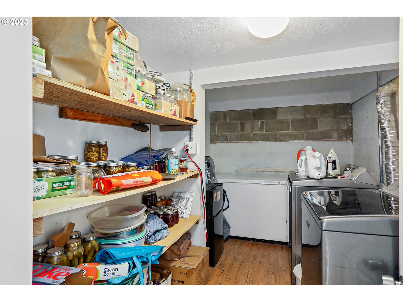 695 Main Street Dufur, OR 97021 - Photo 25 of 42 a utility room with stainless steel appliances and chandelier