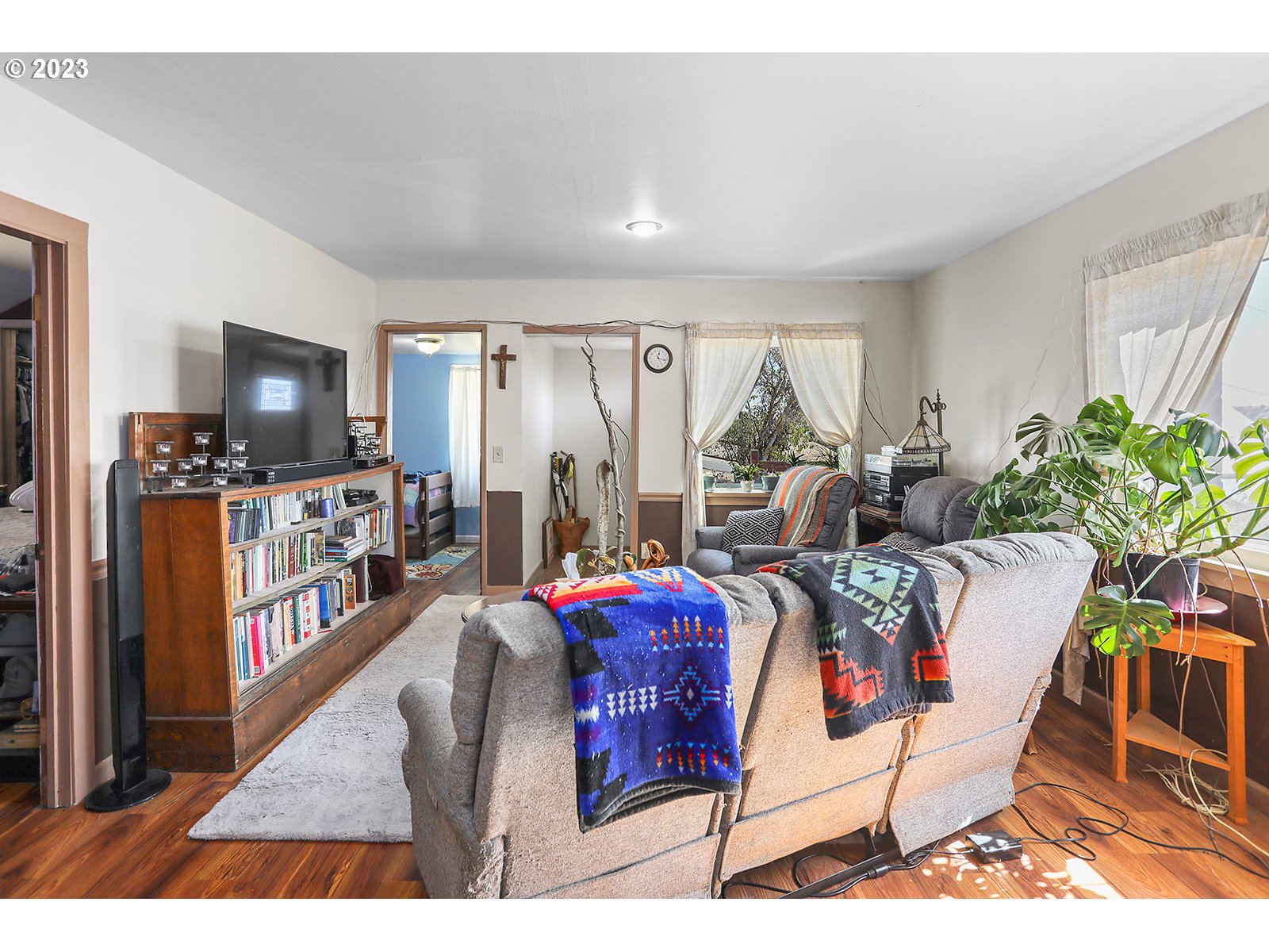 695 Main Street Dufur, OR 97021 - Photo 8 of 42 a living room with furniture a flat screen tv and a floor