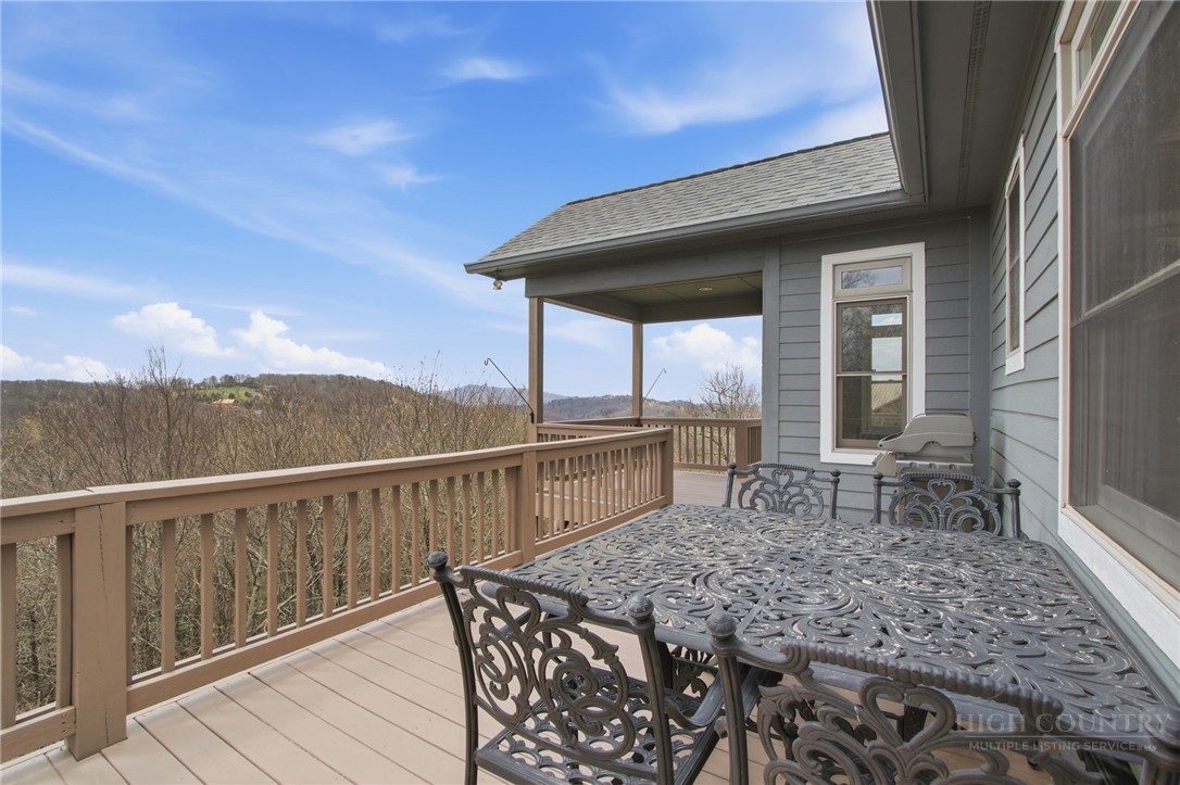 880 Algonquin Drive Boone, NC 28607 - Photo 13 of 50 a roof deck with table and chairs a barbeque with wooden floor and fence