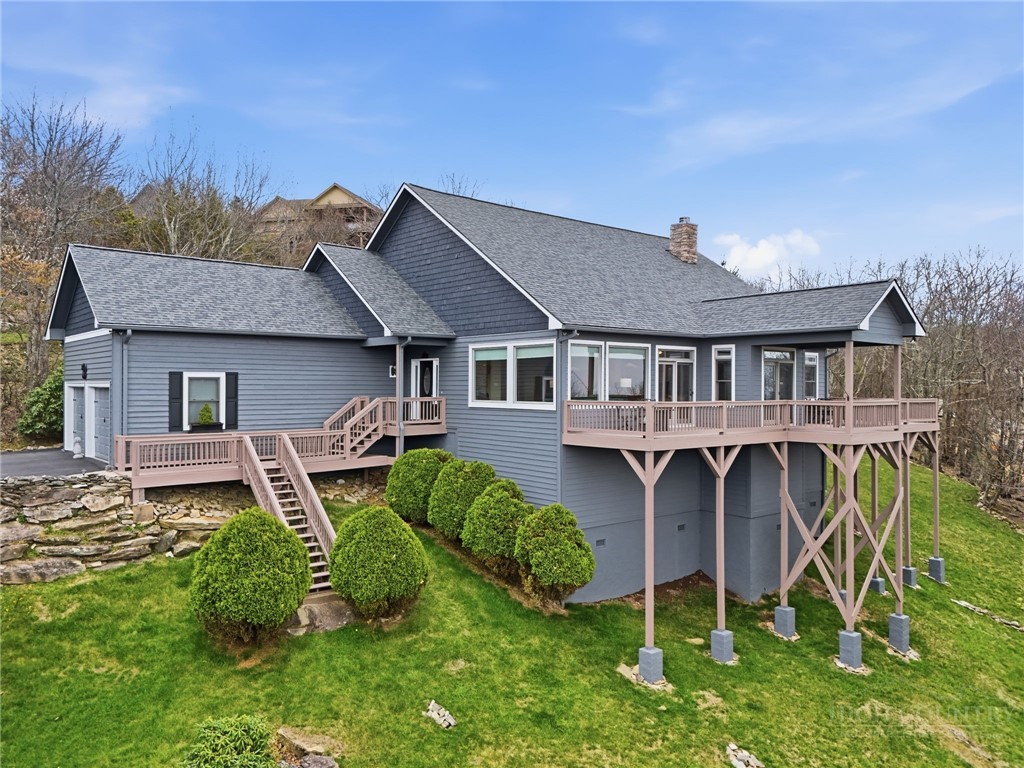 880 Algonquin Drive Boone, NC 28607 - Photo 2 of 50 a front view of a house with garden