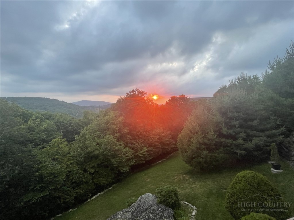 880 Algonquin Drive Boone, NC 28607 - Photo 21 of 50 a view of a lake in middle of forest