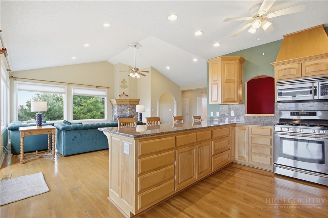 880 Algonquin Drive Boone, NC 28607 - Photo 22 of 50 a large kitchen with kitchen island a large counter space a sink stainless steel appliances and cabinets