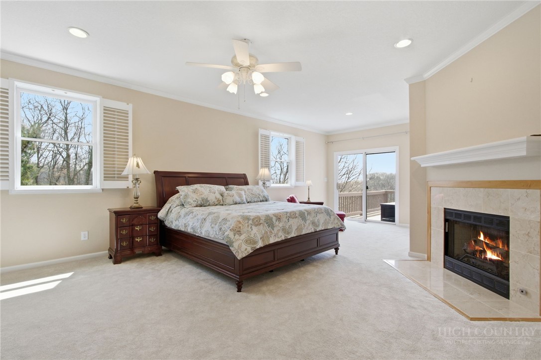 880 Algonquin Drive Boone, NC 28607 - Photo 33 of 50 a bedroom with a bed and a fireplace