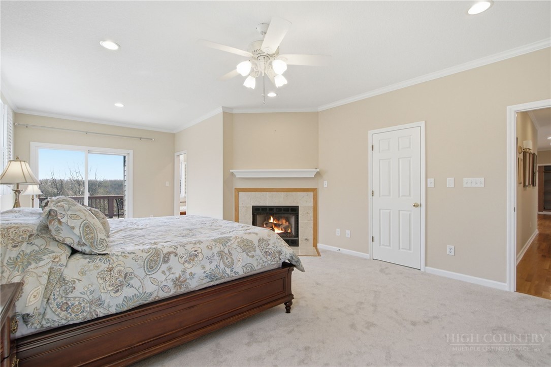 880 Algonquin Drive Boone, NC 28607 - Photo 34 of 50 a bedroom with a bed and a fireplace