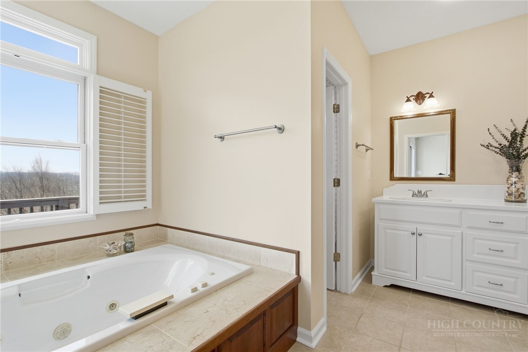 880 Algonquin Drive Boone, NC 28607 - Photo 38 of 50 a bathroom with a tub sink and mirror