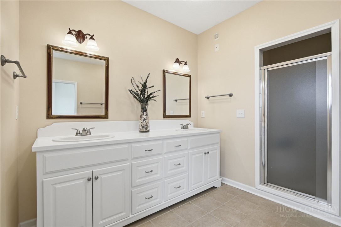 880 Algonquin Drive Boone, NC 28607 - Photo 39 of 50 a bathroom with a double vanity sink and mirror