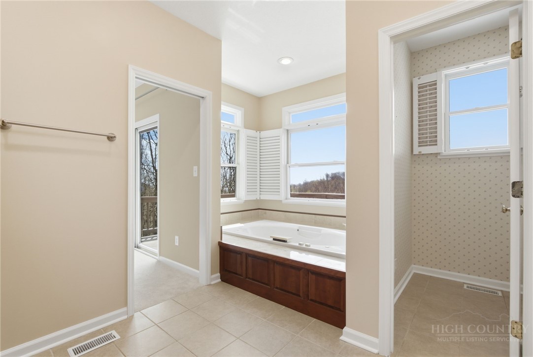 880 Algonquin Drive Boone, NC 28607 - Photo 40 of 50 a bathroom with a tub shower and sink
