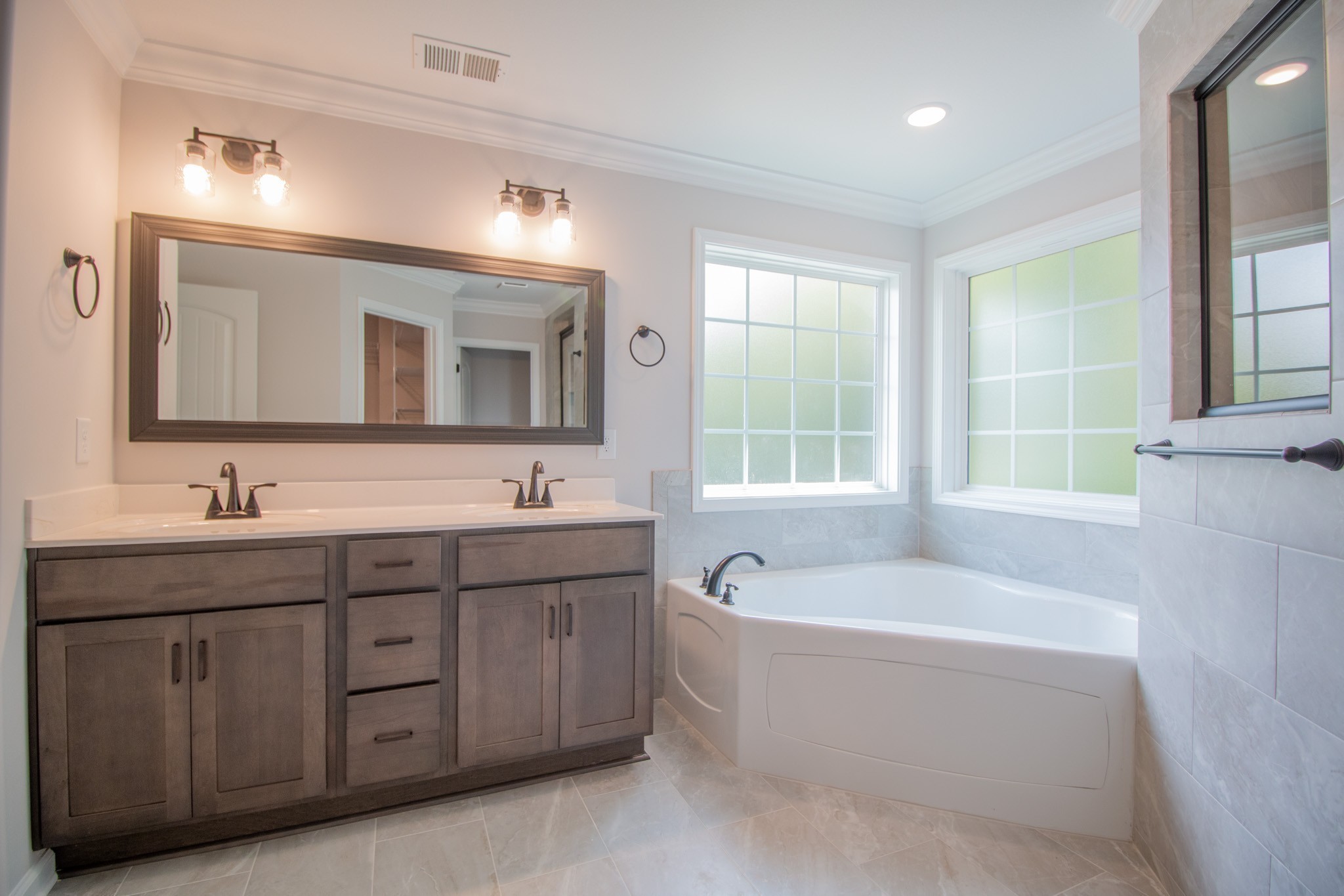 288 Timber Springs Clarksville, TN 37042 - Photo 16 of 25 a bathroom with a tub a sink double vanity and a mirror