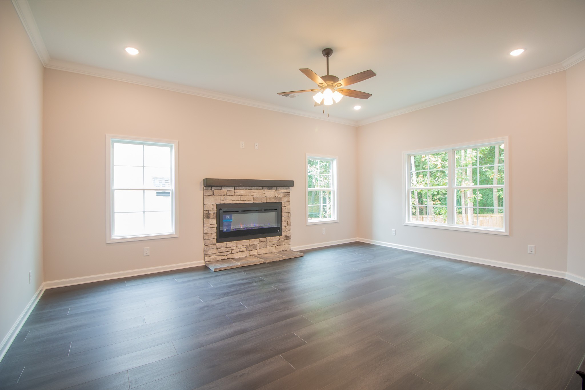 288 Timber Springs Clarksville, TN 37042 - Photo 4 of 25 an empty room with wooden floor fan and windows