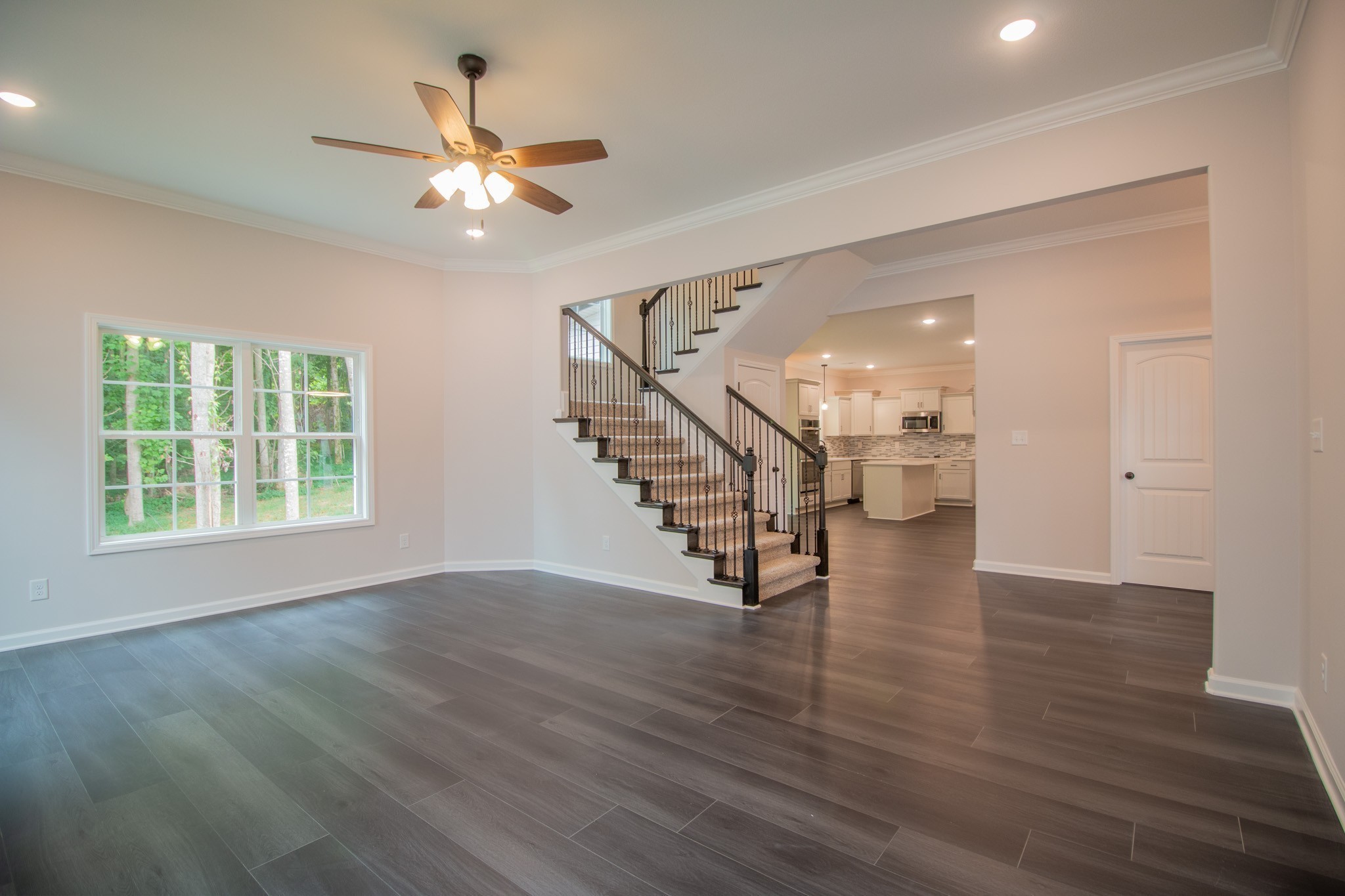 288 Timber Springs Clarksville, TN 37042 - Photo 5 of 25 a view of an empty room with wooden floor and a ceiling fan