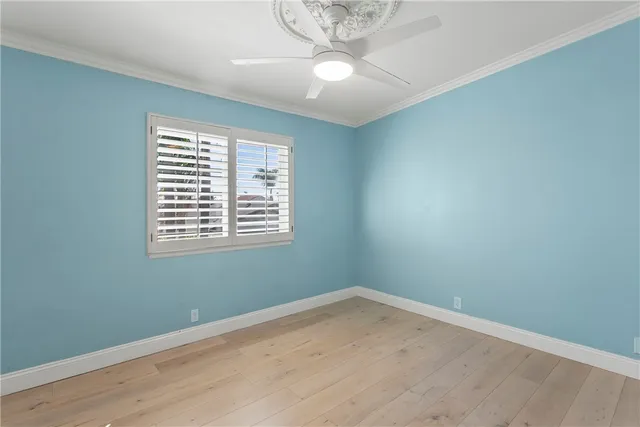 a view of a room with a window and wooden floor
