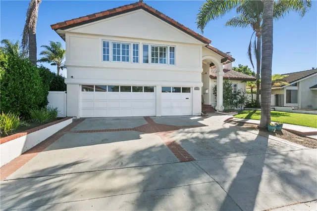 a view of a white house with a yard