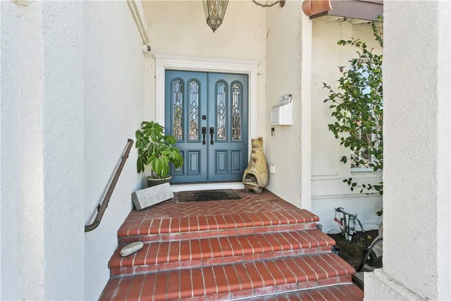 a bedroom with a bed and a potted plant