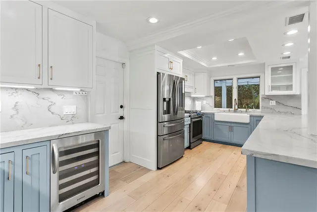 a kitchen with a refrigerator sink and cabinets