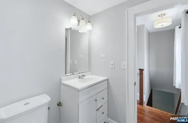 a bathroom with a toilet sink and vanity