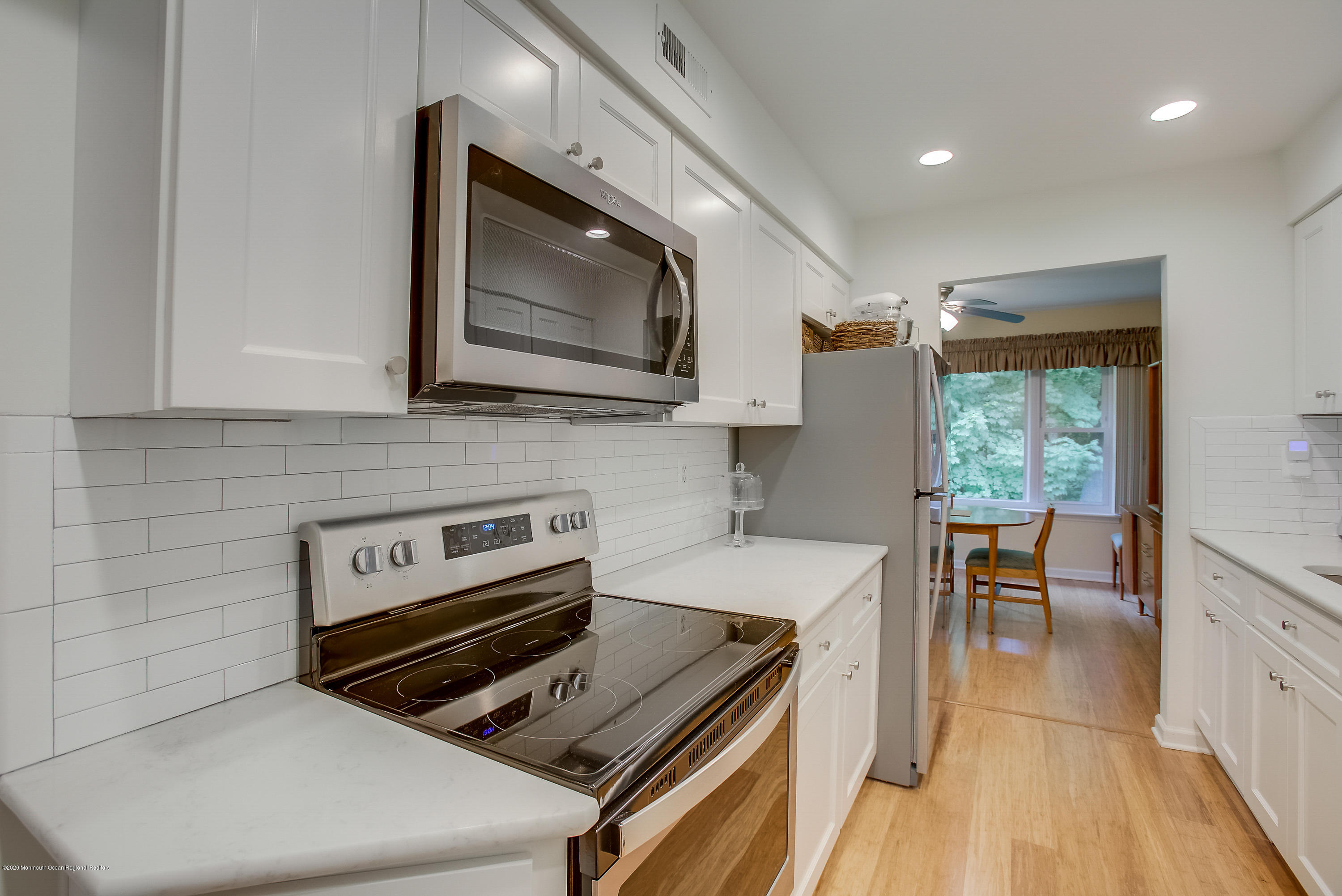 200 Portland Road, Unit E6 Highlands, NJ 07732 - Photo 3 of 30 a kitchen with a stove a sink and a microwave