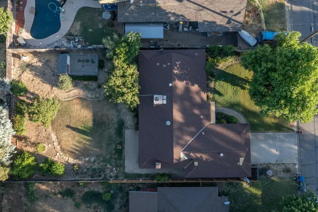 an aerial view of a house with a yard