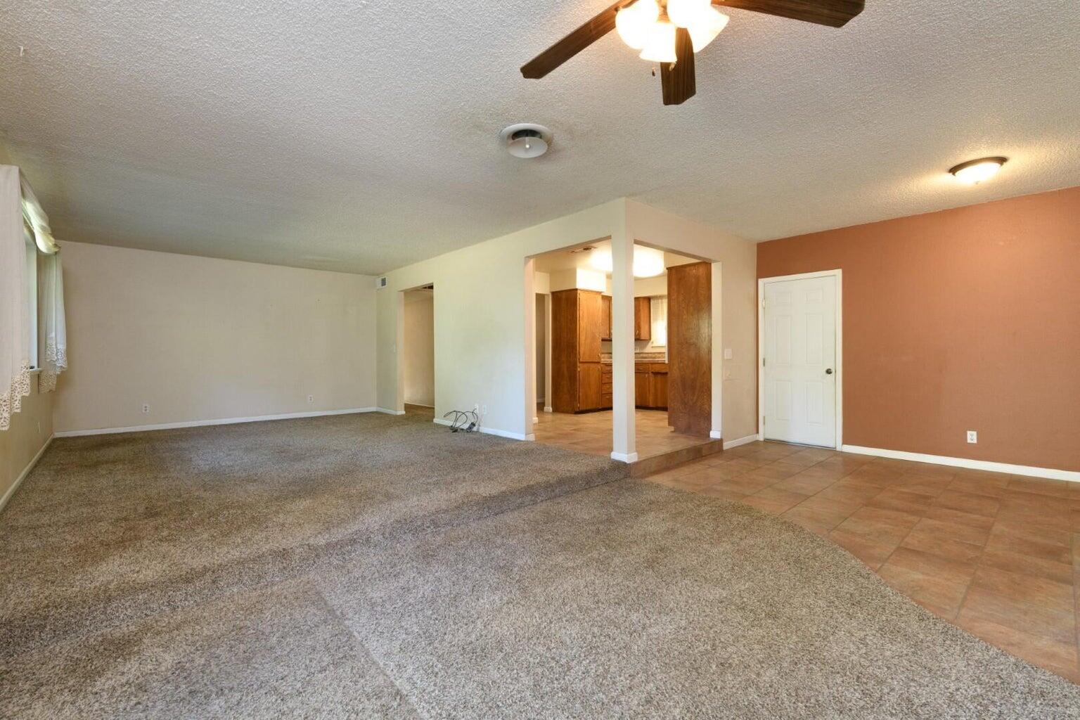 6781 Reflection Street Redding, CA 96001 - Photo 5 of 13 an empty room with windows and fan