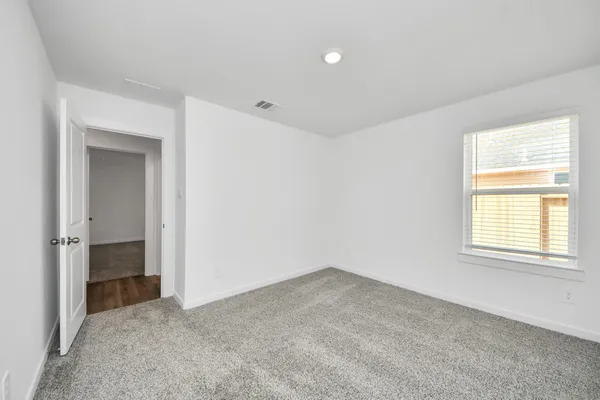 an empty room with windows and closet