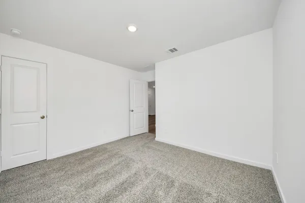 a large kitchen with stainless steel appliances a sink a stove top oven a counter space and cabinets