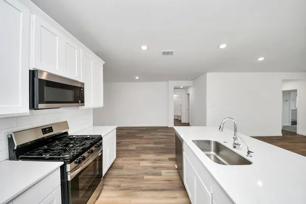 a kitchen with a sink and cabinets