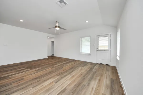 wooden floor in an empty room with a window