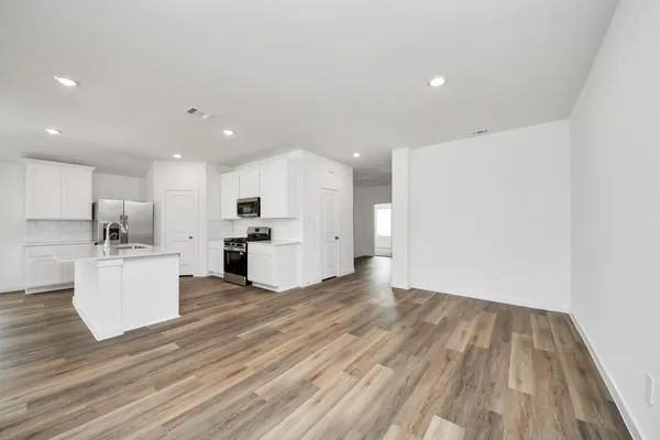 a view of kitchen with furniture and wooden floor