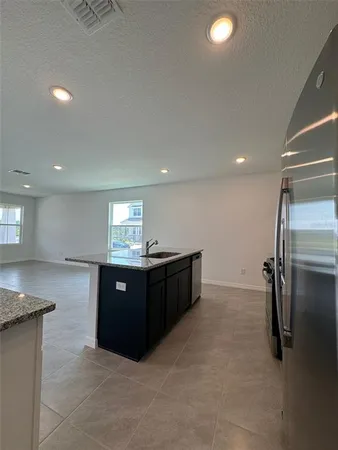 a kitchen with a refrigerator and a sink