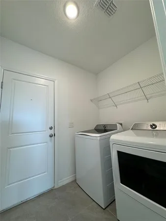 a kitchen with stainless steel appliances granite countertop a sink stove microwave and refrigerator