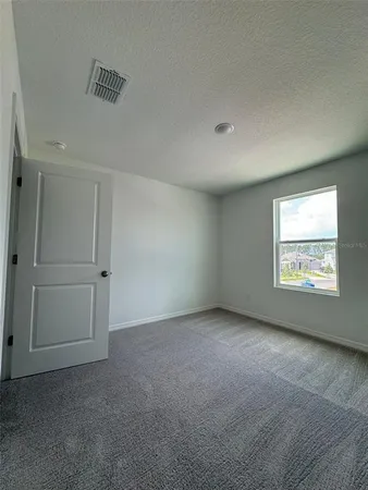 an empty room with a empty space and windows