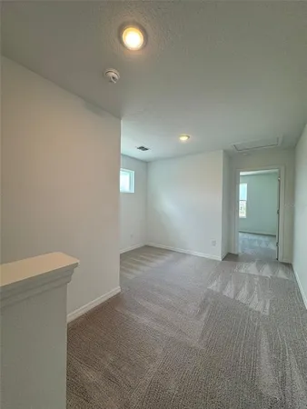 an empty room with closet and a bathroom