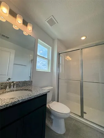 a view of swimming pool with lawn chairs and potted plants