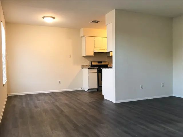 a view of a kitchen with wooden floor