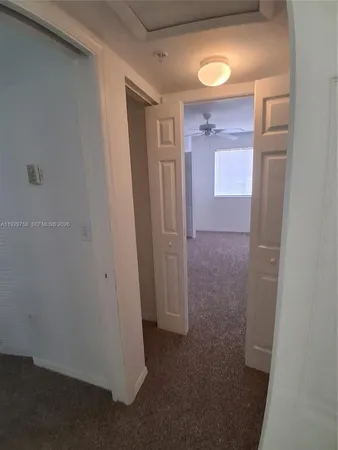 a view of a hallway with closet area