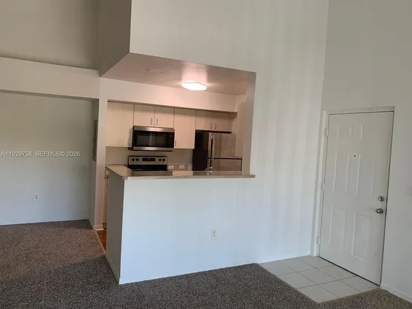 a view of a kitchen from the hallway