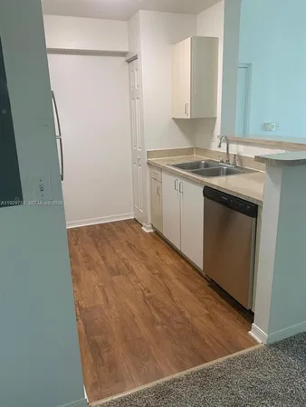 a kitchen with a sink and a refrigerator