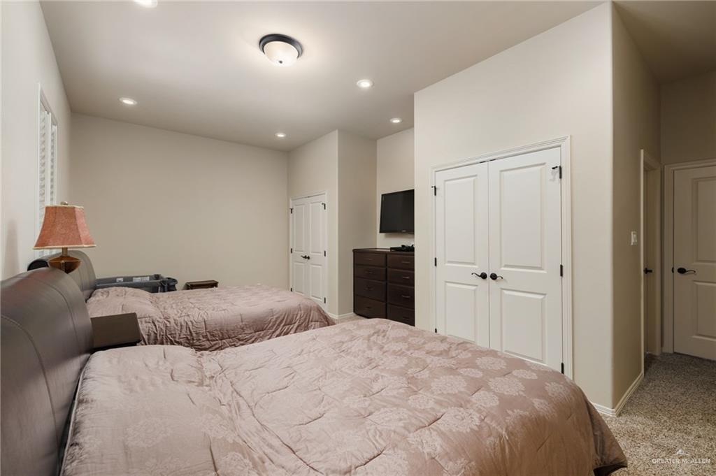 605 Ithaca Avenue McAllen, TX 78501 - Photo 11 of 23 a bedroom with a bed and a refrigerator